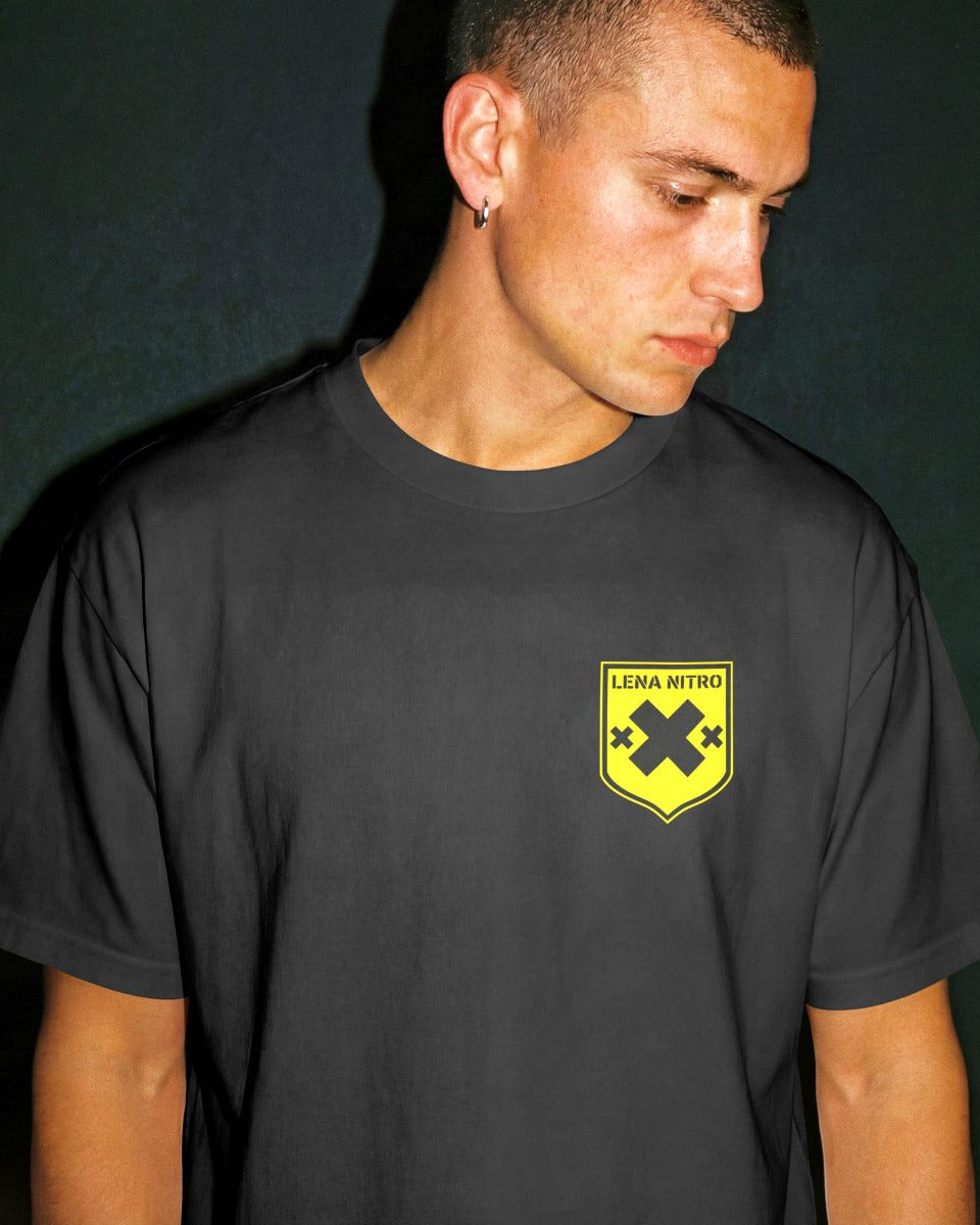 Male model in Lena Nitro black t-shirt with yellow shield