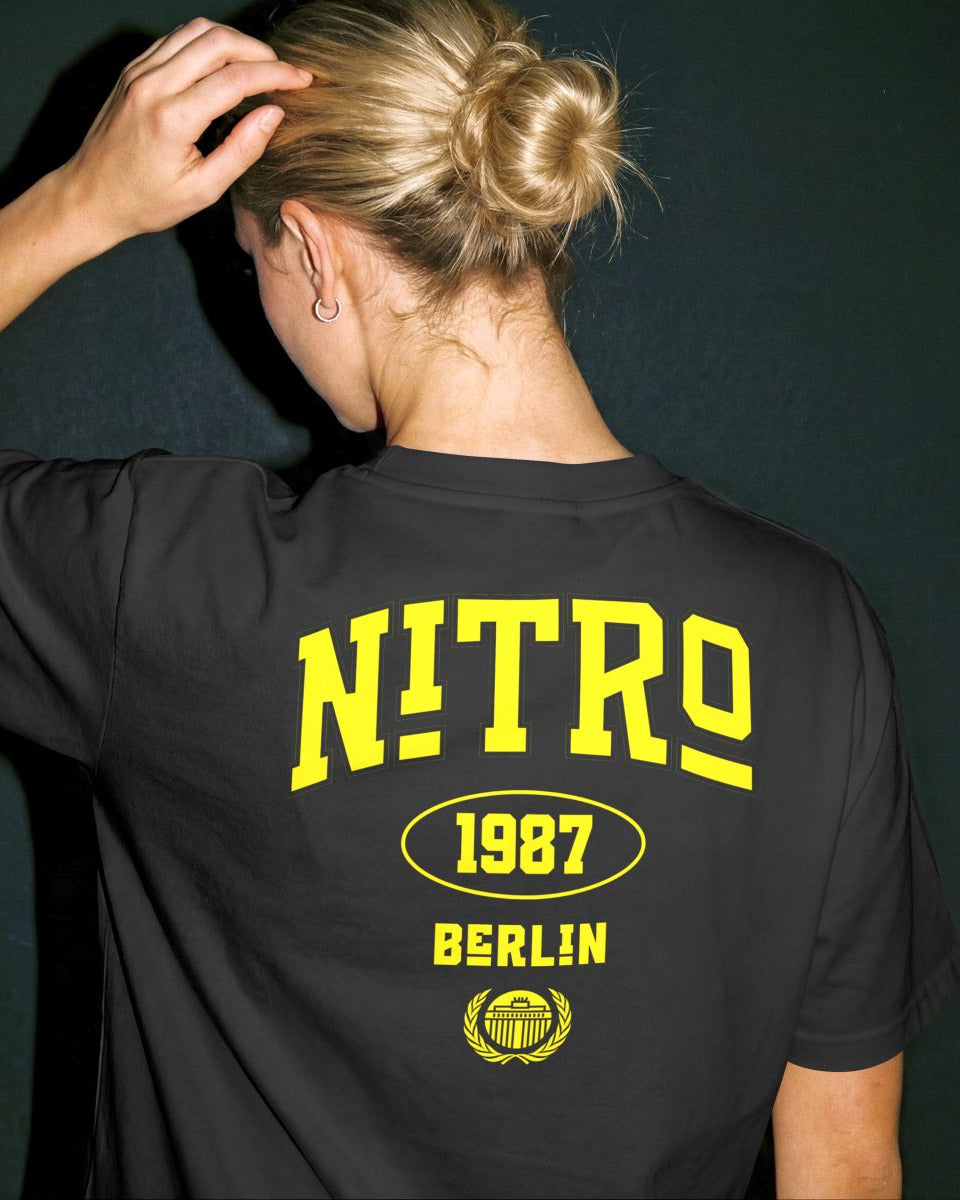 Female model wearing Lena Nitro Berlin yellow logo back