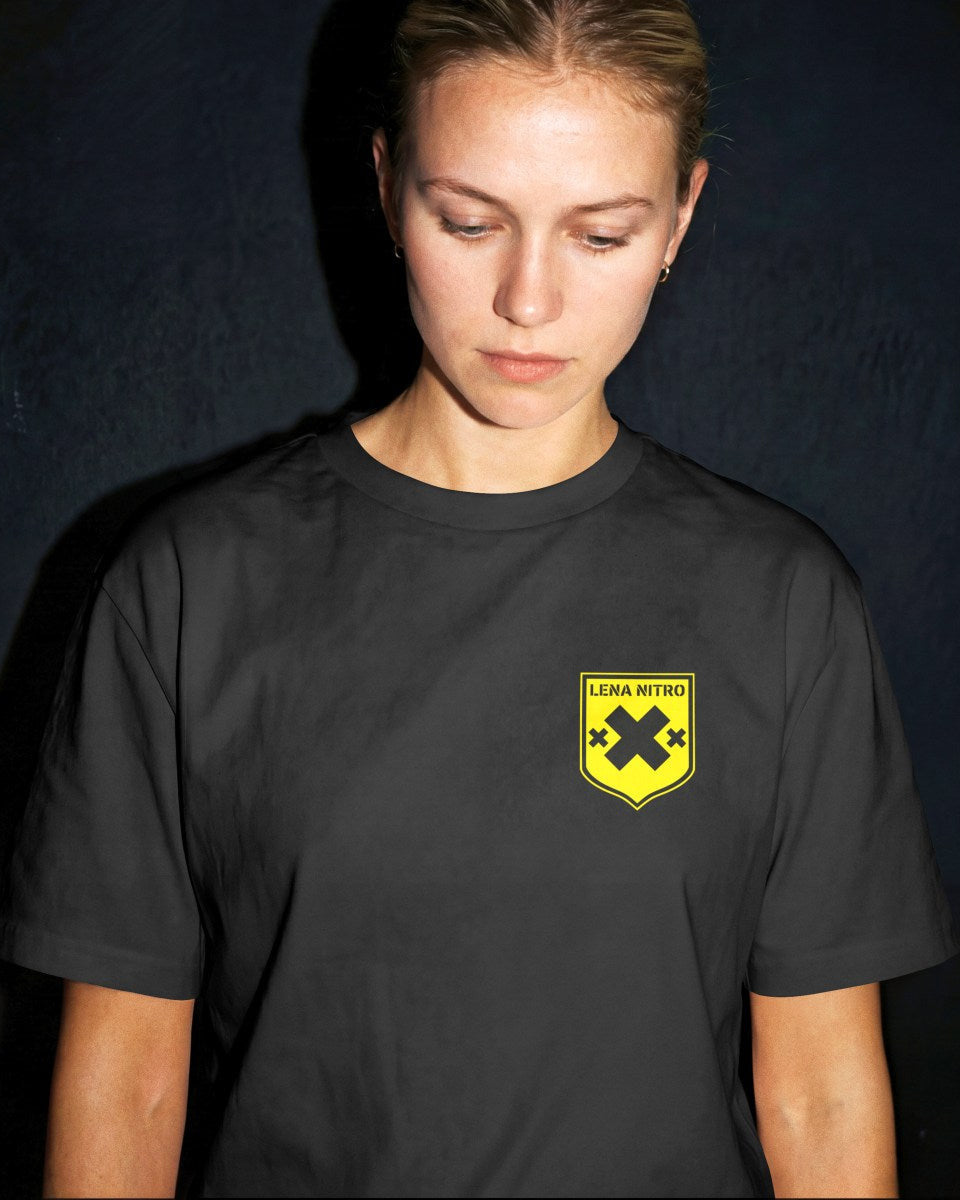 Female model wearing Lena Nitro yellow shield logo shirt